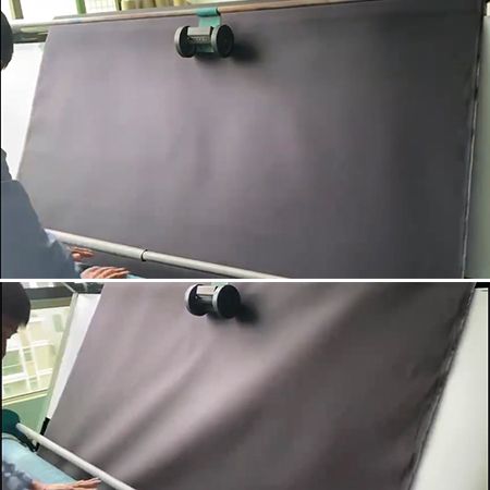 O inspetor verifica a qualidade do tecido na máquina de inspeção de tecidos